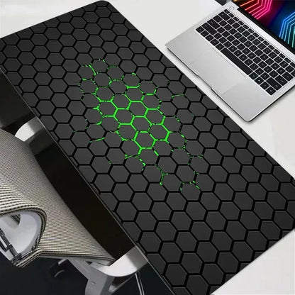 Black honeycomb patterned desk mat with a laptop on a white surface