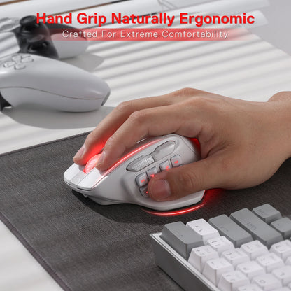 Ergonomic mouse being used by a hand on a desk with keyboard and mouse pad.